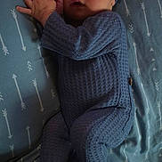 Colt joined the competition — help win amazing prizes! baby, sleeping, blue_outfit, knitted_clothing, hat, bed, sheet, arrow_pattern, infant, peaceful, resting, cozy, newborn, child, portrait, cute, indoor, soft_lighting, hands_together, footed_pajamas