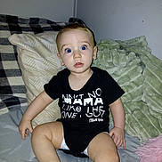 Elijah is registered to the contest to win money with this photo: baby, child, blue_eyes, onesie, yellow_sock, blanket, bed, pillow, indoor, curious, sitting, infant, cute, expression, clothing, person, soft_texture, home, portrait, young