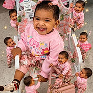 Aisha is registered to the contest to win money with this photo: baby, child, toddler, pink_clothing, smiling, happy, miniature, multiple_babies, chair, handbag, floor, tiles, indoor, playful, cute, joyful, person, patterned_pants, pink_sweater, flower_pattern