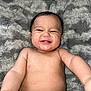 Azariah is registered to the contest to win money with this photo: baby, smiling, diaper, arm, bracelet, blanket, fluffy, face, cheeks, teeth, skin, infant, reaching, lying_down, cute, happy, child, person, indoors, portrait