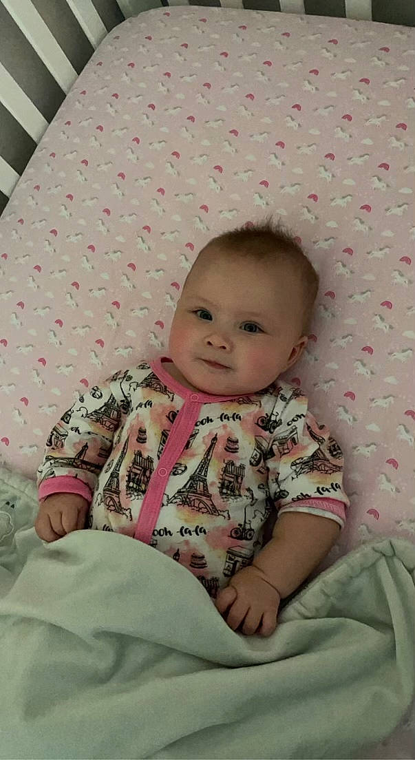 Kallie joined the competition — help win amazing prizes! baby, baby_toddler_clothing, cheek, child, comfort, flooring, happy, linens, pattern, person, pink, product, room, sitting, skin, sleeve, smile, t_shirt, textile, toddler