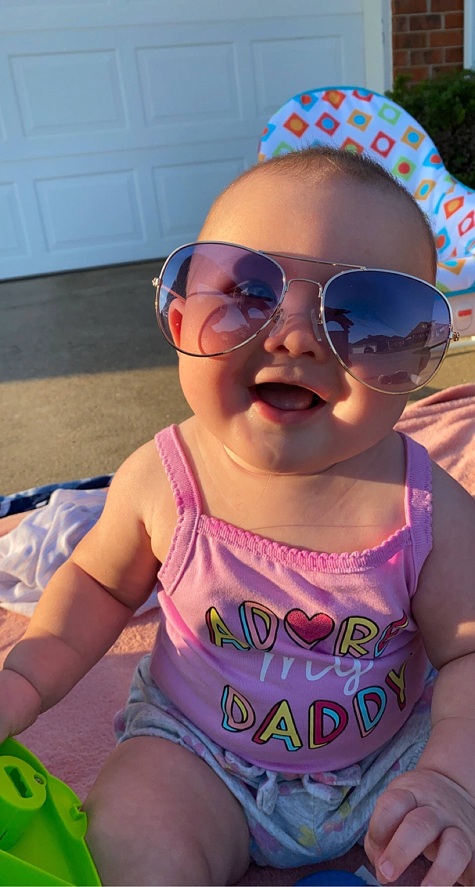 Kallie is registered to the contest to win money with this photo: active_tank, baby_toddler_clothing, blue, cap, clothing, cool, eyewear, glasses, goggles, happy, headgear, lip, mouth, person, pink, skin, smile, sunglasses, textile, thigh