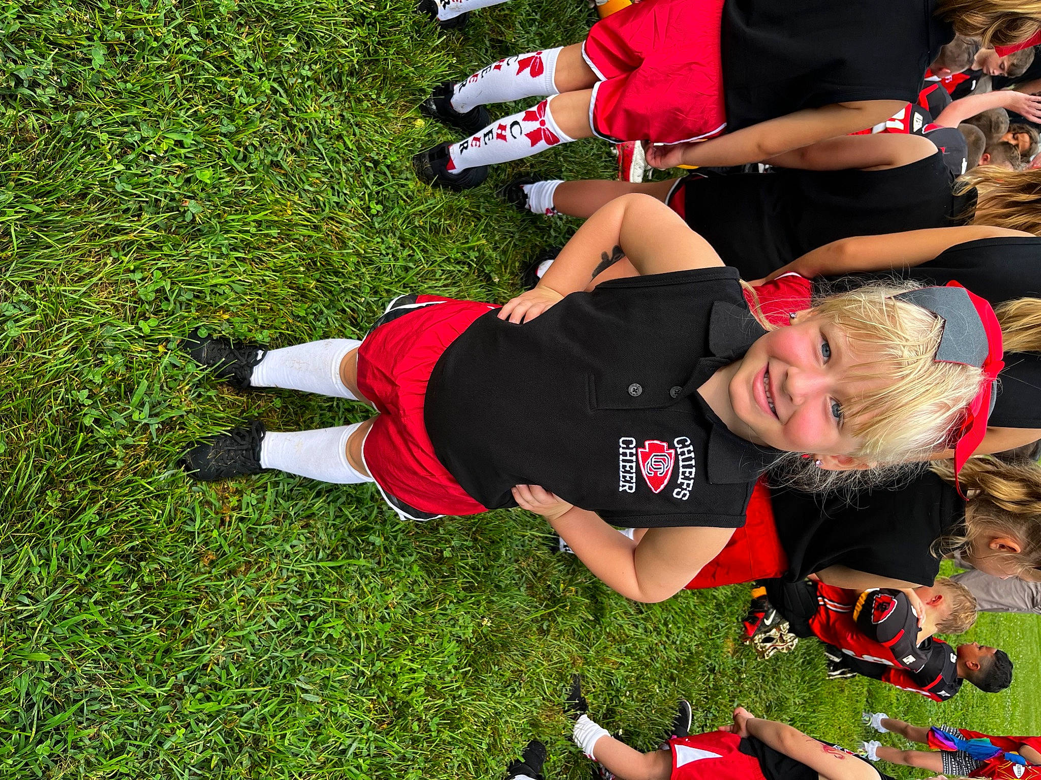 Hadleigh is registered to the contest to win money with this photo: competition_event, event, grass, happy, human_leg, joy, knee, leisure, people_in_nature, person, player, recreation, red, shoe, shorts, sneakers, sock, sports, sports_uniform, team