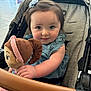 toddler, child, stroller, plush_doll, toy, blue_flower, hair_clip, smile, curious, indoor, cute, baby, denim_dress, pink_pants, soft_toy, portrait, infant, hand, face, young_child