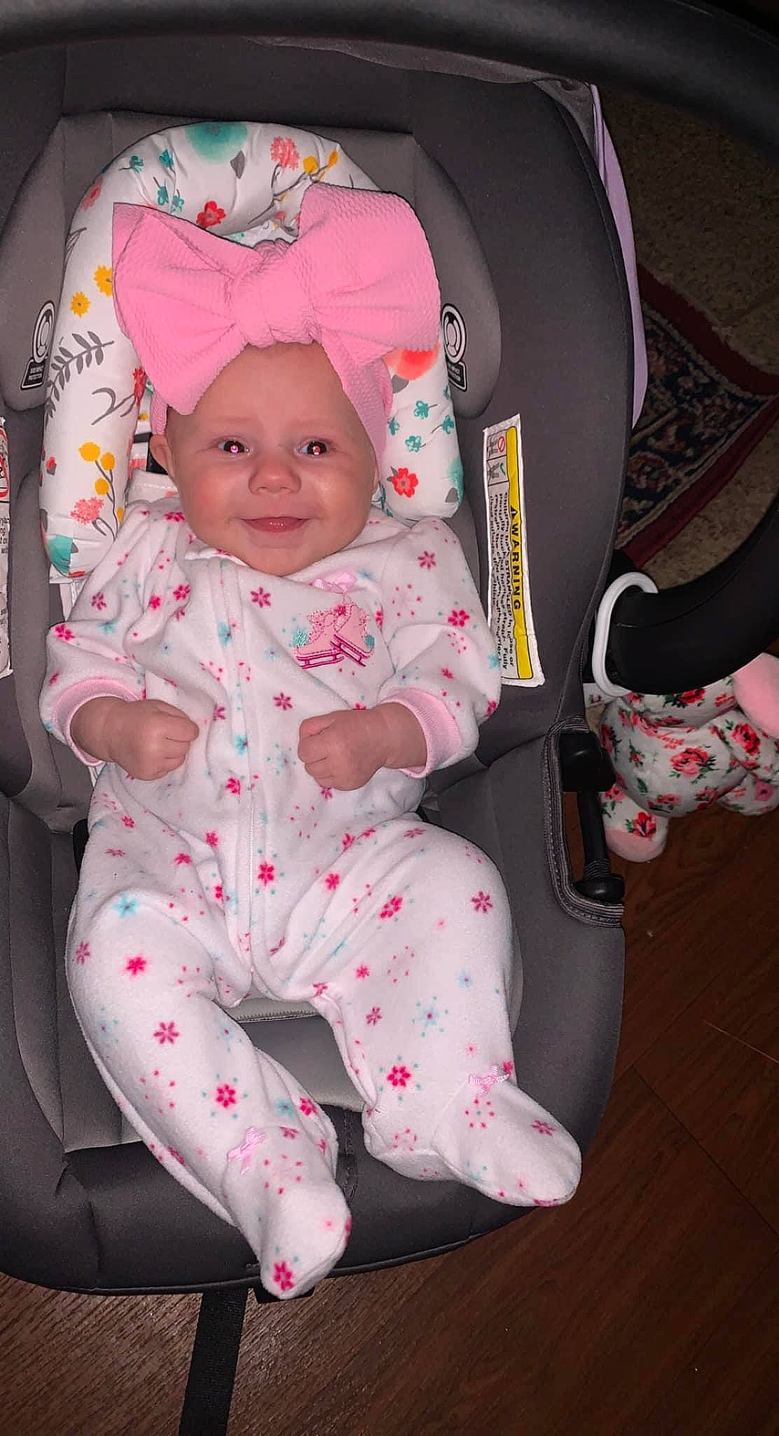 Raina joined the competition — help win amazing prizes! baby, baby_carriage, baby_products, baby_safety, baby_toddler_clothing, car_seat, cheek, child, comfort, eye, face, head, headwear, joy, lap, linens, pattern, person, pink, product