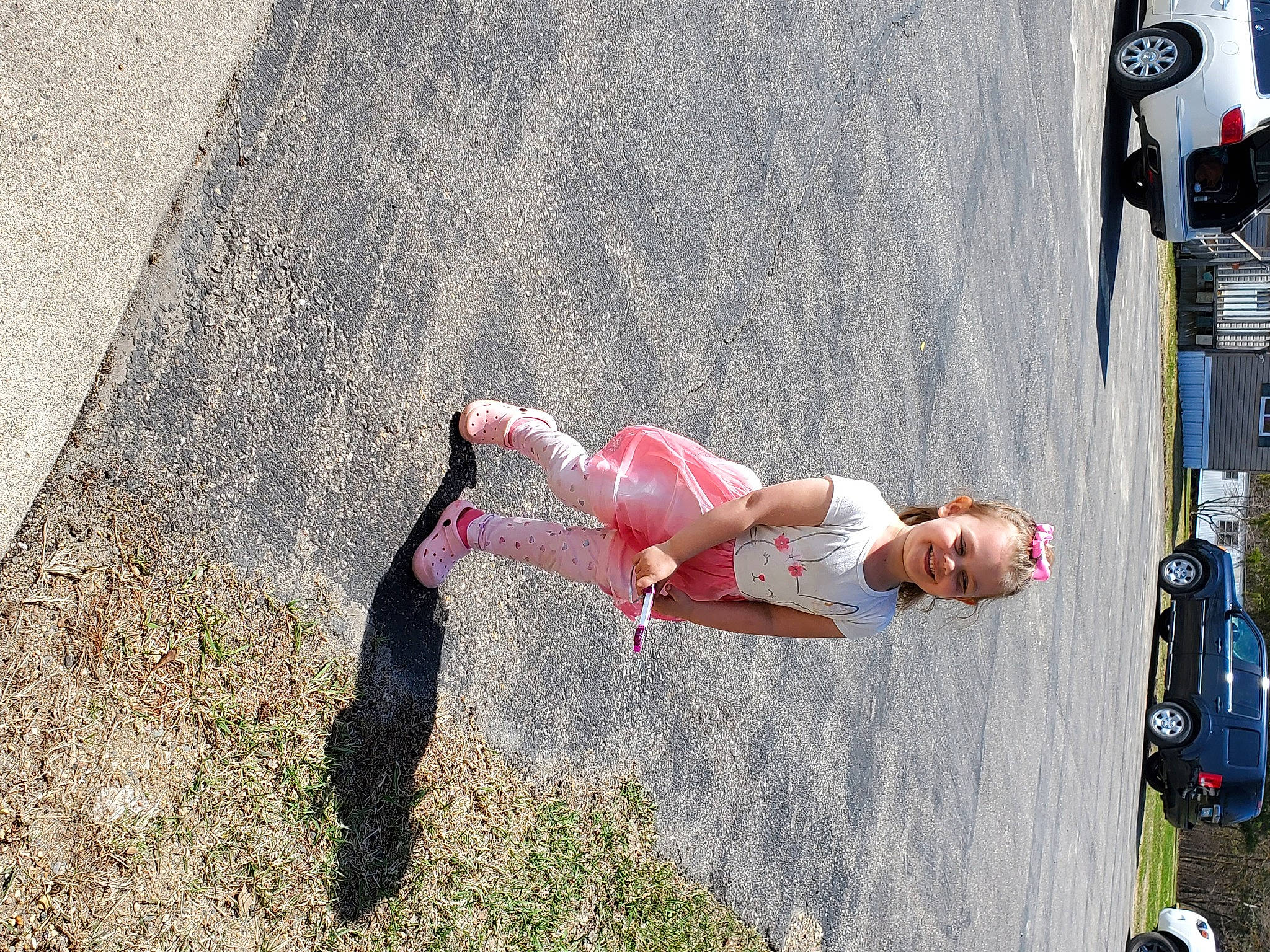 Isabella Marie joined the competition — help win amazing prizes! asphalt, car, concrete, family_car, grass, human_leg, joy, leisure, pedestrian, person, recreation, road, road_surface, rolling, shorts, sidewalk, soil, sport_climbing, tire, toddler