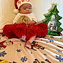 Billie Jean joined the competition — help win amazing prizes! baby, blanket, celebration, child, christmas, christmas_tree_decoration, cute, decor, festive, holiday, indoor, infant, person, portrait, red_tutu, santa_hat, seasonal, smiling, snowman, toy