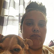 Cricket Lynn Greene is registered to the contest to win money with this photo: casual, chain, closeup, comfort, curtains, dog, expression, face, furniture, hand, indoor, jewelry, light, person, pet, piercing, portrait, resting, shadow, window