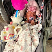 Na Mora is registered to the contest to win money with this photo: baby, sleeping, car_seat, blanket, pacifier, headband, flower, plush_toy, unicorn, pink, child, infant, soft_toys, indoor, cute, cozy, resting, toddler, fabric, comfort
