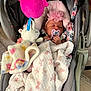 baby, sleeping, car_seat, blanket, pacifier, headband, flower, plush_toy, unicorn, pink, child, infant, soft_toys, indoor, cute, cozy, resting, toddler, fabric, comfort
