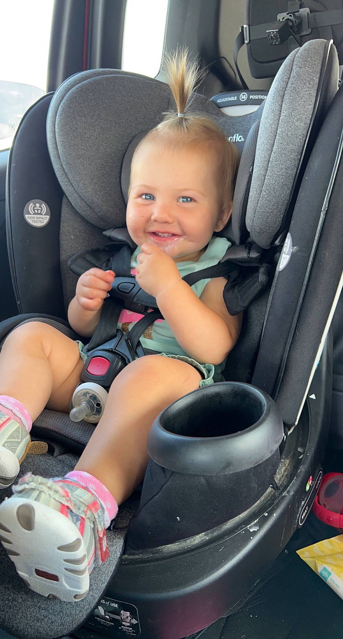 Sutton is registered to the contest to win money with this photo: auto_part, automotive_design, automotive_tire, car_seat, car_seat_cover, comfort, hubcap, joy, leg, light, motor_vehicle, person, photograph, plant, product, smile, sneakers, tire, toddler, vehicle_door