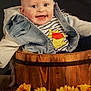baby, child, smiling, face, denim_jacket, striped_shirt, cartoon_character, wooden_bucket, sunflowers, flowers, happy, portrait, indoor, cute, sitting, clothing, person, head, bright_eyes, rustic