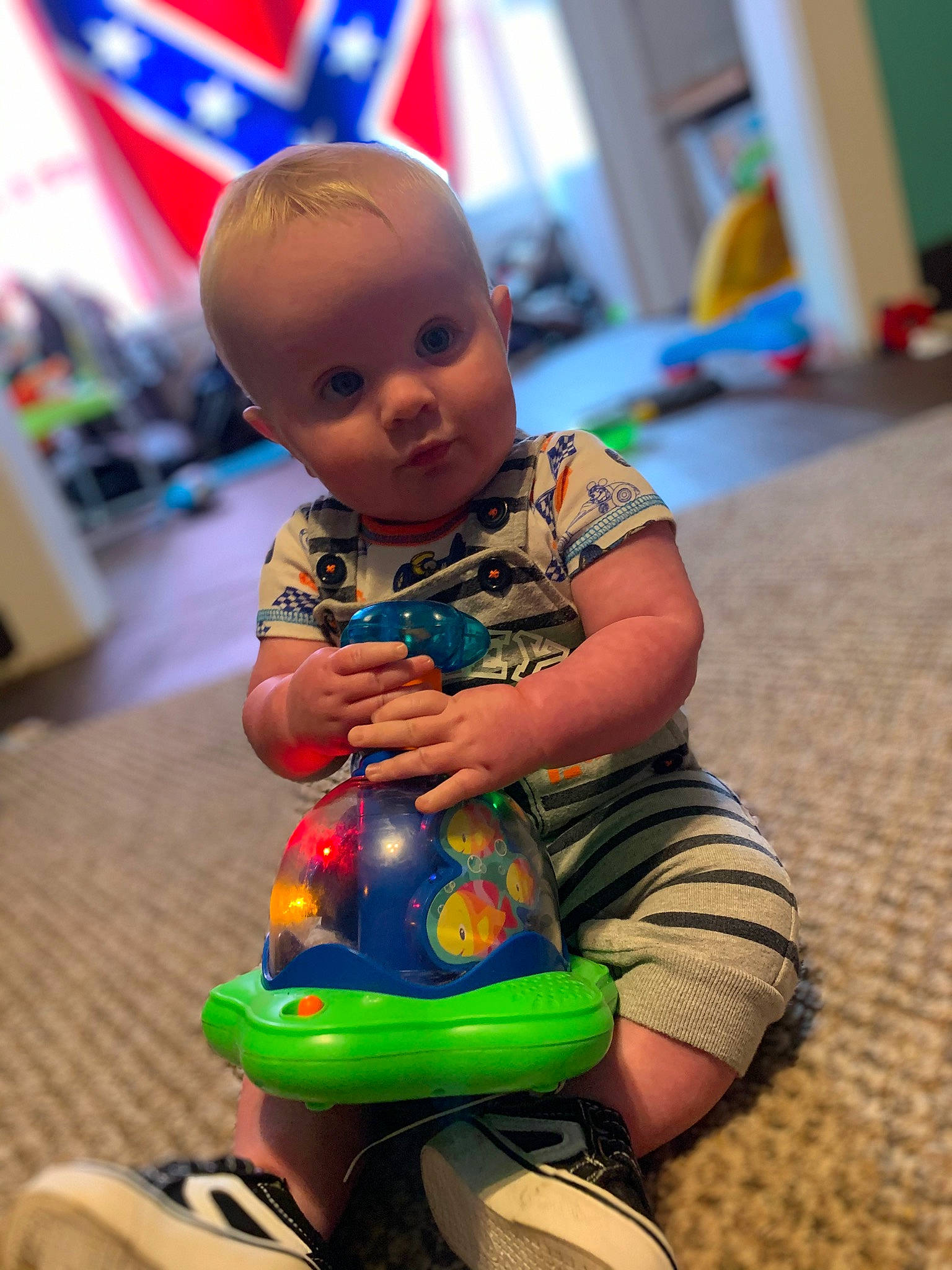 Darius joined the competition — help win amazing prizes! baby, blue, child, event, flag, floor, flooring, fun, happy, human_leg, leisure, person, play, sitting, standing, summer, t_shirt, thigh, toddler, toy