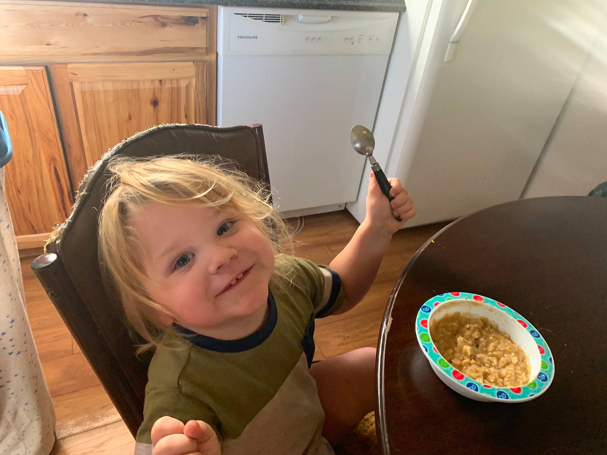 Dwayne is registered to the contest to win money with this photo: beauty, cabinetry, chair, cooking, drawer, finger, food, fun, hairstyle, joy, organ, person, plate, recipe, shirt, smile, snapshot, standing, t_shirt, table