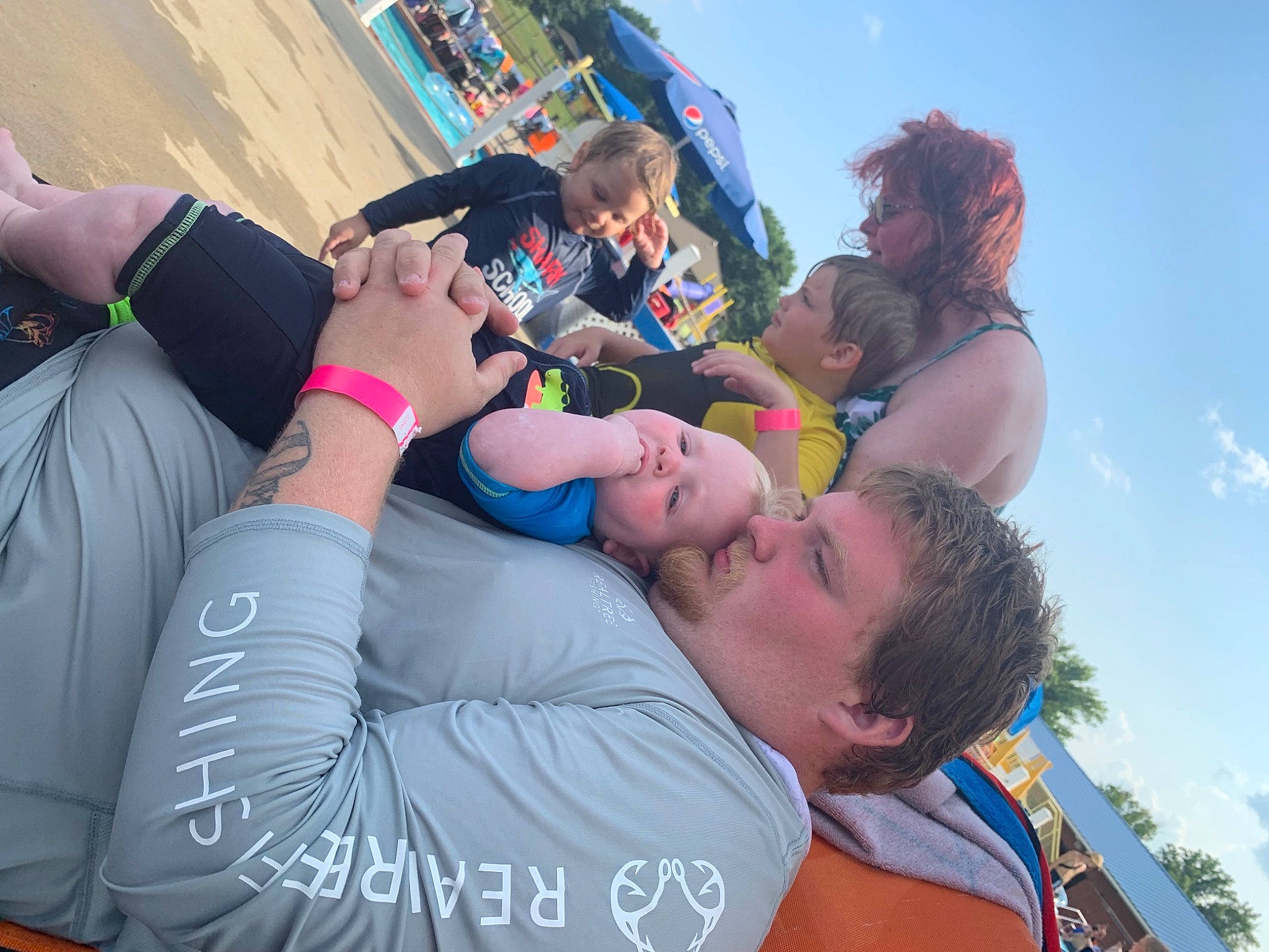 Dwayne is registered to the contest to win money with this photo: cloud, crowd, drink, event, eyewear, friendship, fun, gesture, happy, hat, landscape, leisure, party, people_on_beach, person, public_event, recreation, sky, sunglasses, t_shirt