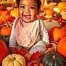 baby, child, infant, smiling, happy, portrait, curly_hair, sitting, autumn, fall, pumpkins, gourds, leaves, orange, harvest, seasonal, outdoor, bib, clothing, ai_generated
