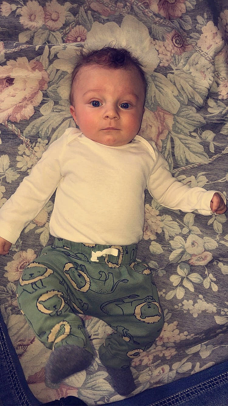 Waylon James is registered to the contest to win money with this photo: arm, baby, baby_toddler_clothing, cheek, comfort, eye, face, facial_expression, finger, hairstyle, head, iris, mouth, nose, organ, person, skin, sleeve, standing, textile