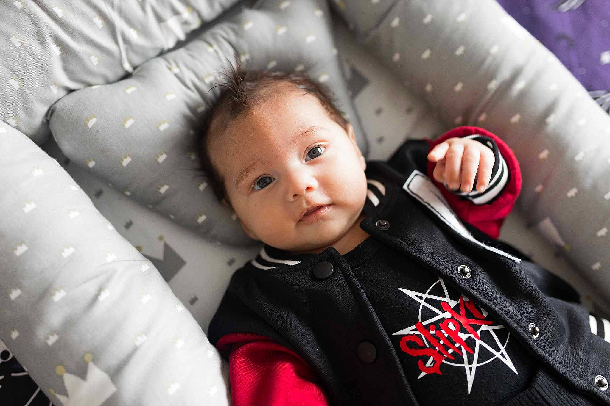 Anakin is registered to the contest to win money with this photo: automotive_design, baby, baby_carriage, baby_toddler_clothing, car_seat, carmine, child, comfort, event, flash_photography, formal_wear, fun, happy, head, pattern, person, product, sitting, sleeve, t_shirt