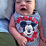 Xzavion joined the competition — help win amazing prizes! baby, child, mickey_mouse, clothing, onesie, smiling, face, arm, hand, skin, portrait, infant, cute, striped, text, blue, red, white, soft_surface, happy