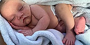Xzavion is registered to the contest to win money with this photo: baby, sleeping, blanket, soft, cozy, infant, newborn, skin, foot, hand, diaper, peaceful, closeup, portrait, rest, comfort, cute, wrapped, nap, child