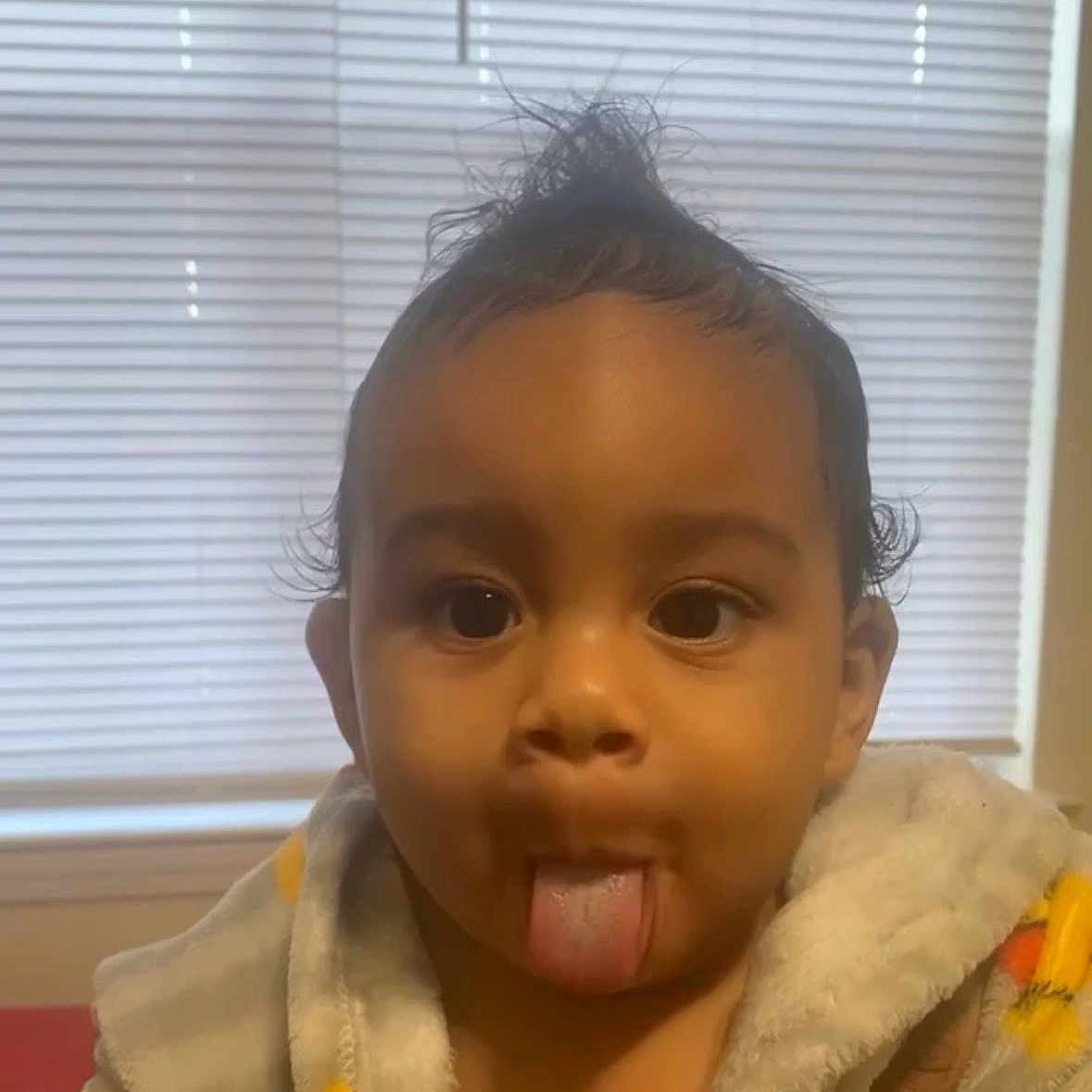 Kamaz joined the competition — help win amazing prizes! toddler, child, face, tongue_out, hair, indoor, bathrobe, cute, expression, window, blinds, skin, person, portrait, playful, young_child, sitting, funny_face, hair_style, cozy