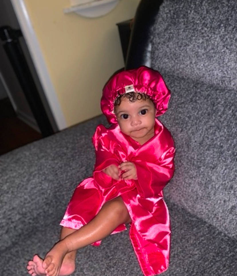 Samira joined the competition — help win amazing prizes! baby, baby_toddler_clothing, child, costume_hat, dress, event, fashion_accessory, fashion_design, flooring, fun, happy, headwear, human_leg, magenta, person, pink, purple, room, sitting, sleeve