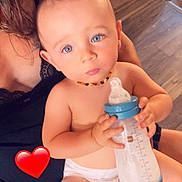 Samson participe au concours pour gagner de l'argent avec cette photo : baby, blue_eyes, casual, child, closeup, cute, diaper, flooring, hand, heart_emoji, holding, indoor, infant, milk_bottle, necklace, person, sitting, skin, wallpaper, young