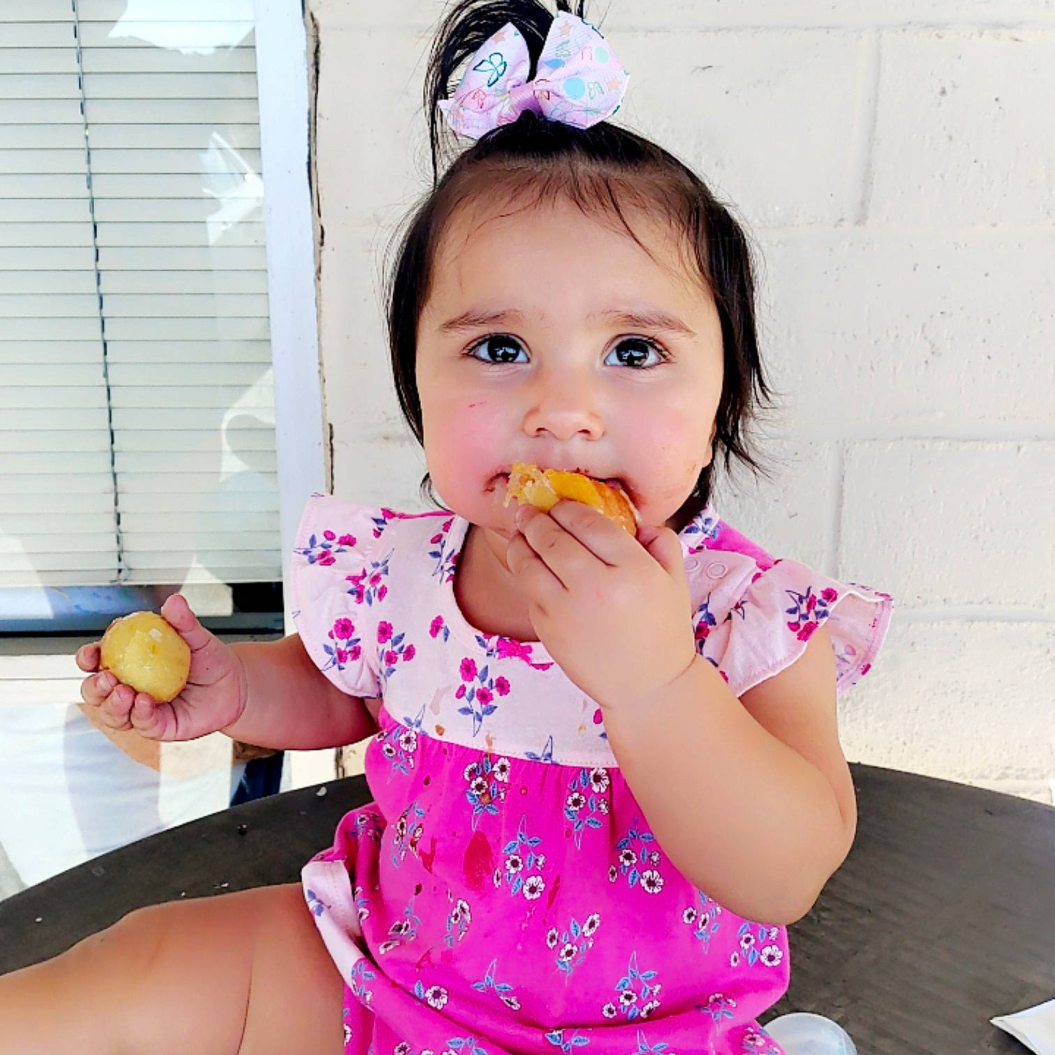 Christine is registered to the contest to win money with this photo: baby, baby_toddler_clothing, child, dress, eating, finger, food_craving, fun, gesture, happy, nail, neck, person, pink, plate, play, sleeve, sweetness, tableware, thumb