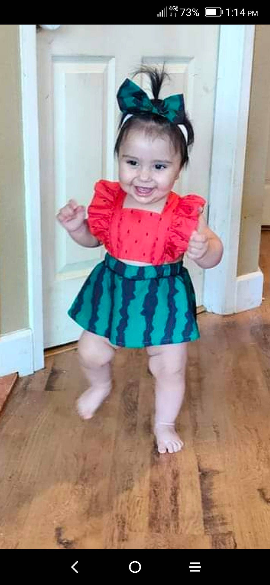 Christine is registered to the contest to win money with this photo: baby_toddler_clothing, clothing, day_dress, dress, eye, face, flooring, hair, happy, hardwood, head, joy, one_piece_garment, person, pink, purple, sleeve, smile, toddler, trunk