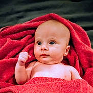 Charlotte joined the competition — help win amazing prizes! baby, infant, towel, red, skin, bare_chest, blanket, expression, face, head, eyes, hand, fist, lying_down, indoor, portrait, cute, child, newborn, soft_texture