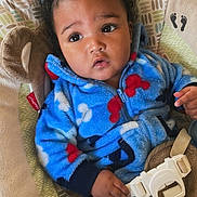 Nehemiah joined the competition — help win amazing prizes! baby, infant, child, blue_onesie, baby_seat, cushion, curly_hair, indoors, portrait, comfortable, expression, seatbelt, screenshot, phone_interface, text_overlay, young_child, casual, cozy, cute, small_hands
