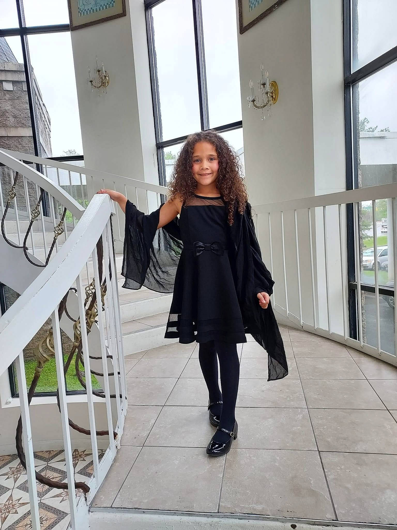 Ava is registered to the contest to win money with this photo: architecture, blazer, boot, collar, denim, fashion_design, footwear, formal_wear, human_leg, joy, knee, outerwear, overcoat, pattern, person, shoe, sleeve, stairs, standing, thigh