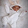Josiah joined the competition — help win amazing prizes! baby, infant, bunny_ears, onesie, white_clothing, fluffy_rug, cute, lying_down, portrait, child, soft_texture, cozy, warm, small_hands, small_feet, indoor, adorable, face, expression, young