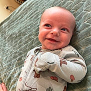 Sebastian joined the competition — help win amazing prizes! baby, smiling, onesie, cowboy_theme, blanket, infant, cute, happy, lying_down, clothing, child, portrait, face, hand, indoor, soft_texture, zipped, small_person, baby_garment, cozy