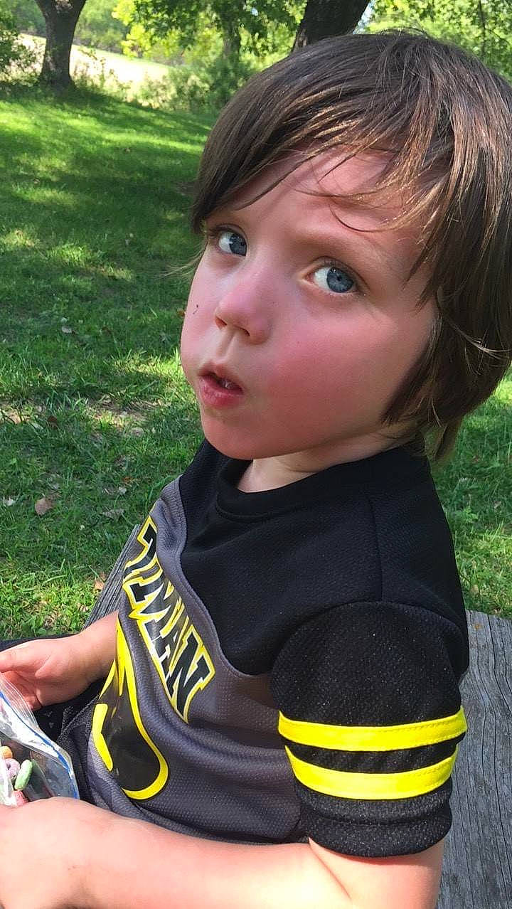 Brantley Johnson is registered to the contest to win money with this photo: blond, brown_hair, child, child_model, cool, eye, face, grass, hair, hairstyle, head, neck, nose, person, smile, t_shirt, toddler, yellow