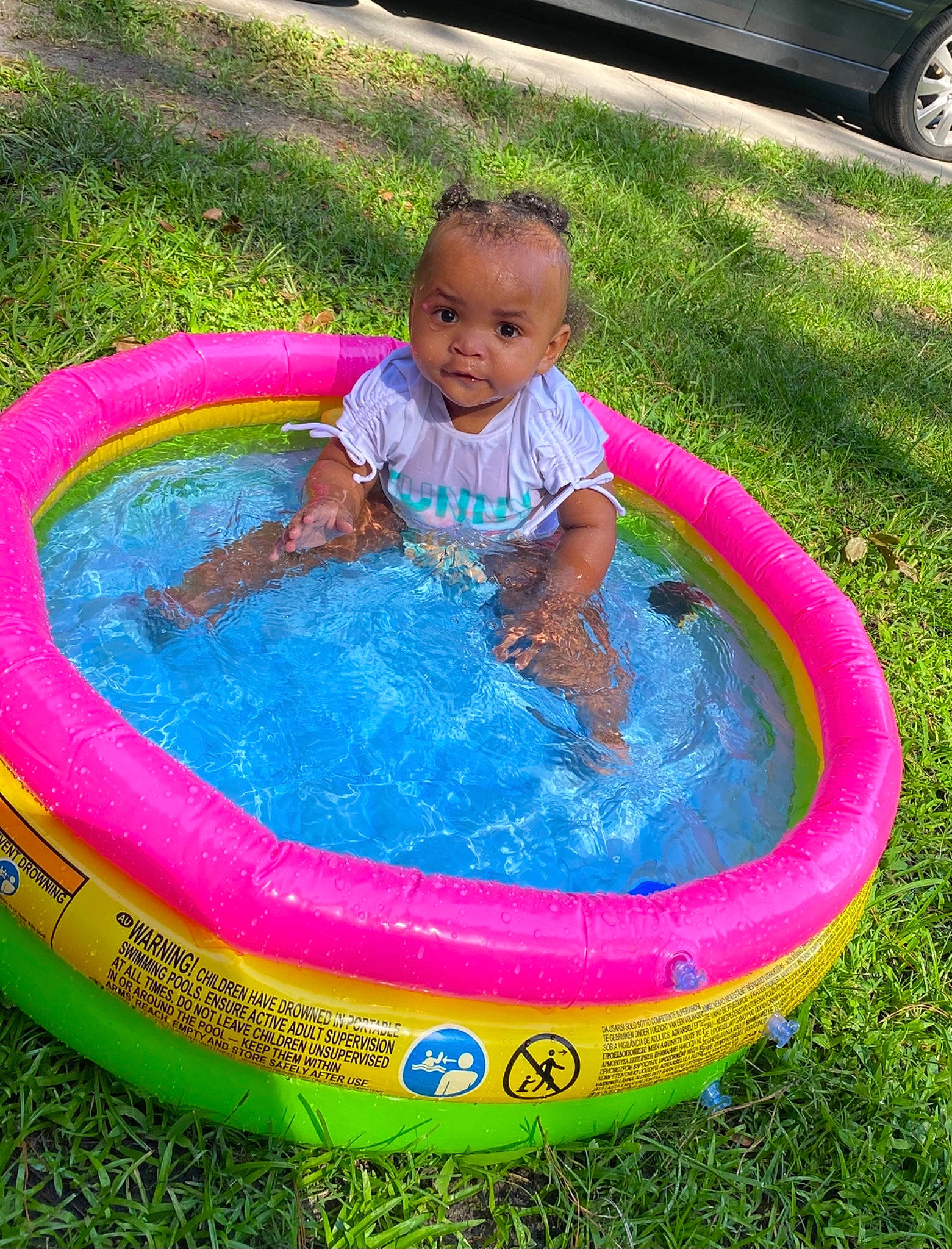 Royale is registered to the contest to win money with this photo: baby, baby_toddler_clothing, bathing, child, circle, composite_material, fun, games, grass, inflatable, leisure, nonbuilding_structure, person, play, recreation, tire, toddler, vacation, water, wheel