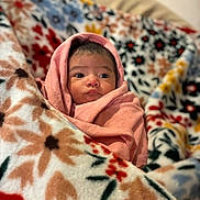 Cataleya is registered to the contest to win money with this photo: baby, blanket, pink_blanket, floral_pattern, cozy, infant, wrapped, cute, face, portrait, soft_texture, warm, indoor, comfort, child, young, expression, looking_away, head, sleeping_area
