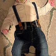 Reece is registered to the contest to win money with this photo: baby, carpet, casual, child, clothing, cute, denim, floor, home, indoor, infant, jeans, laying_down, pacifier, person, portrait, shirt, sock, suspenders, young_child
