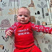 Reece joined the competition — help win amazing prizes! baby, child, clothing, cute, eyes, face, floor_mat, foam_mat, giraffe_pattern, hand, head, indoor, infant, lying_down, neutral_expression, onesie, patterned_background, play_mat, portrait, red_clothing