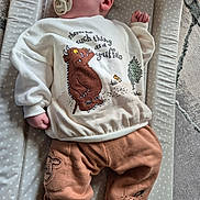 Reece joined the competition — help win amazing prizes! baby, infant, pacifier, clothing, sweatshirt, pants, animal_character, gruffalo, changing_pad, polka_dots, face, hand, footwear, indoor, carpet, soft_toys, cute, child, lying_down, comfort