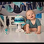 baby, birthday, cake, blue, white, celebration, child, decorations, festive, floor, happy, messy, one, photography, portrait, smiling, studio, toddler, young, cute