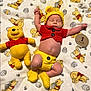 baby, infant, sleeping, plush_toy, winnie_the_pooh, yellow, red, crochet_clothing, blanket, milestone_marker, cute, newborn, soft_toy, baby_clothes, baby_booties, baby_hat, lying_down, indoors, child, resting