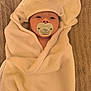 baby, pacifier, towel, hooded_towel, white, wrapped, infant, face, cute, lying_down, blanket, soft, child, sleepy, texture, brown, comfort, resting, indoors, portrait