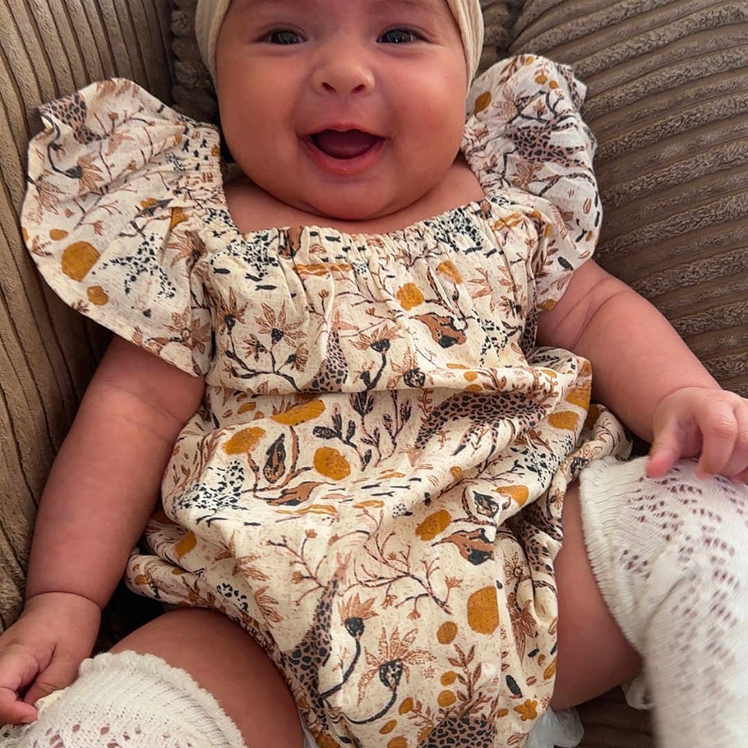 Vergilia joined the competition — help win amazing prizes! baby, bow, child, closeup, comfort, couch, cozy, cute, floral_dress, furniture, happy, headband, indoors, infant, knit_socks, patterned_clothing, portrait, sitting, smiling, soft_lighting