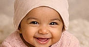 Avika joined the competition — help win amazing prizes! baby, smiling, child, infant, face, pink_hat, pink_sweater, knitwear, happy, cute, portrait, closeup, indoors, warm, soft_light, cozy, young_child, headwear, expression, person