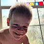 Walker joined the competition — help win amazing prizes! child, smiling, window, hair, face, indoor, shirtless, light, natural_light, toy_blocks, colorful_blocks, playful, happy, young, portrait, candid, daylight, background, glass, expression