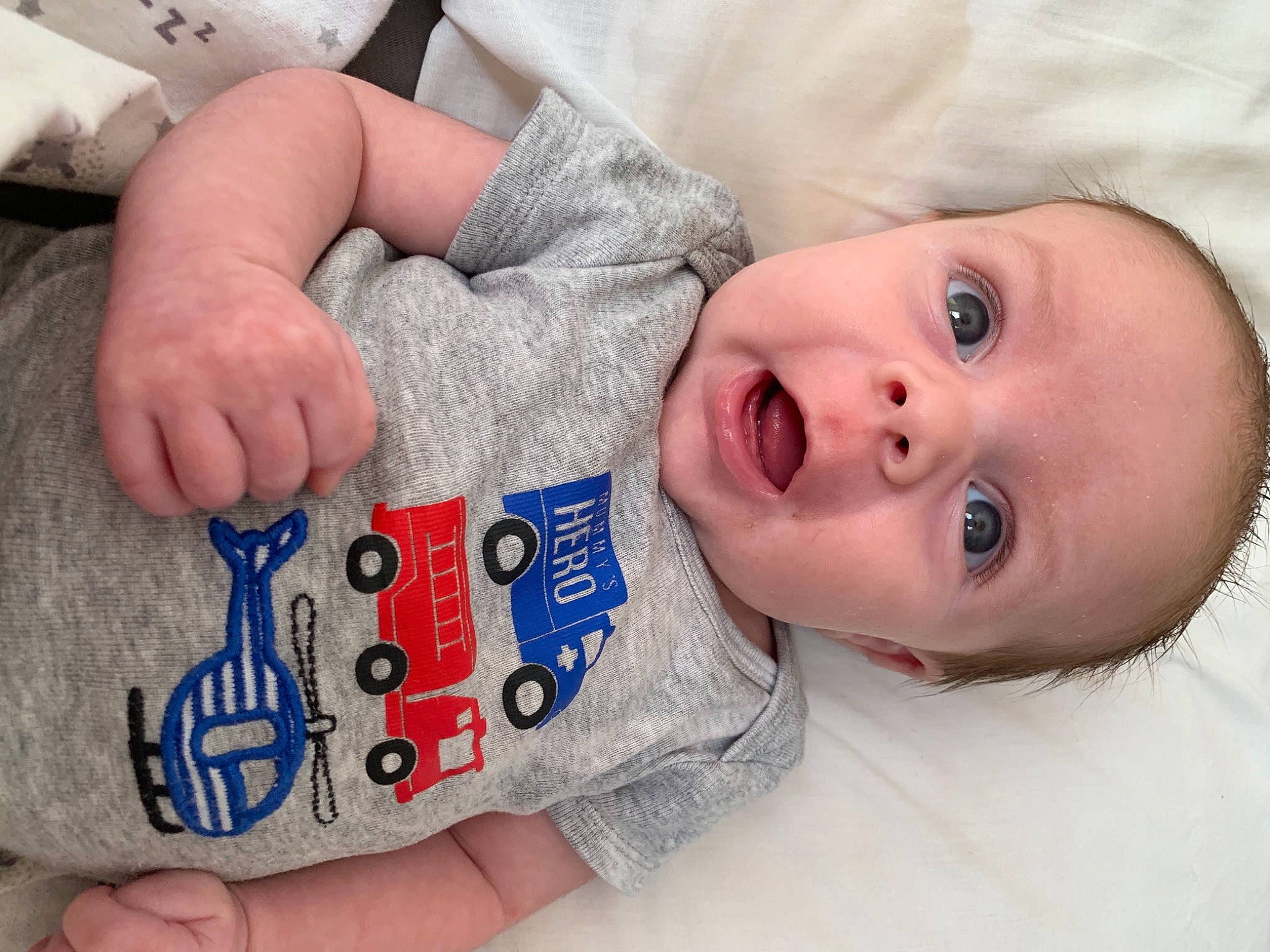 Jaxson is registered to the contest to win money with this photo: baby, baby_toddler_clothing, cheek, child, comfort, elbow, eye, finger, gesture, hand, happy, lip, mouth, nail, nose, person, skin, sleeve, surprise, thumb