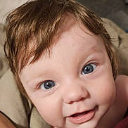 Chloe joined the competition — help win amazing prizes! baby, closeup, face, blue_eyes, smile, hair, skin, infant, child, cute, portrait, expression, toddler, young, human, looking, happy, indoors, soft_light, blanket