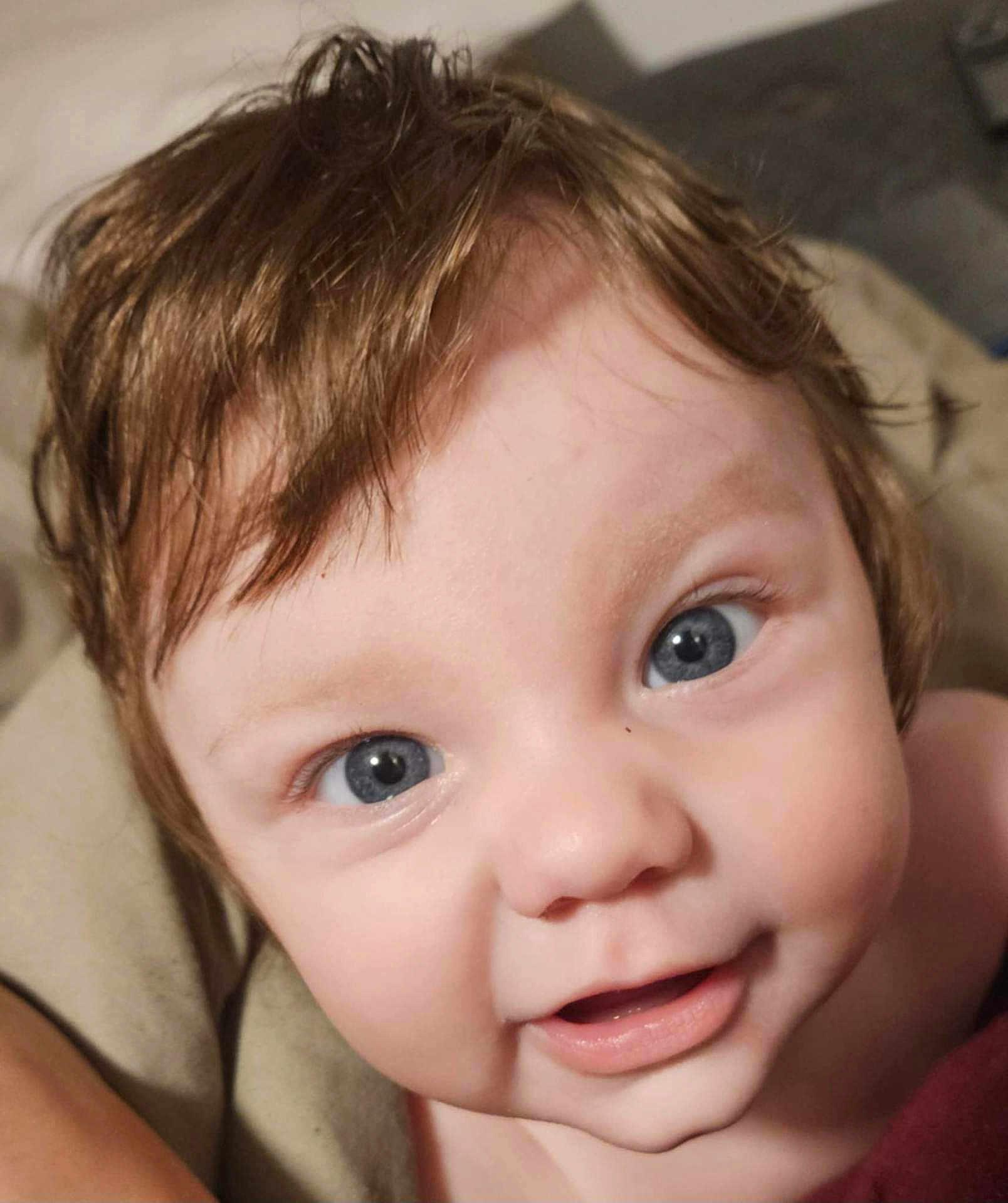 Chloe joined the competition — help win amazing prizes! baby, closeup, face, blue_eyes, smile, hair, skin, infant, child, cute, portrait, expression, toddler, young, human, looking, happy, indoors, soft_light, blanket