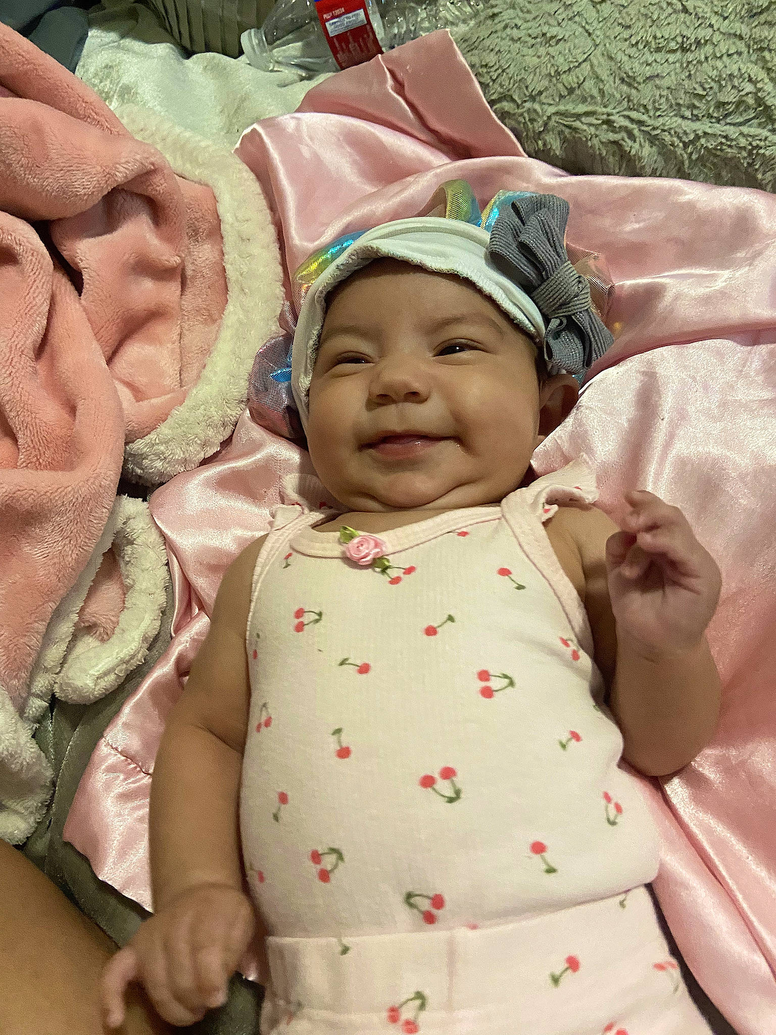 Heavenly is registered to the contest to win money with this photo: baby, baby_products, baby_toddler_clothing, cheek, child, chin, comfort, event, happy, head, headgear, headwear, linens, mouth, person, pink, product, skin, sleeve, smile